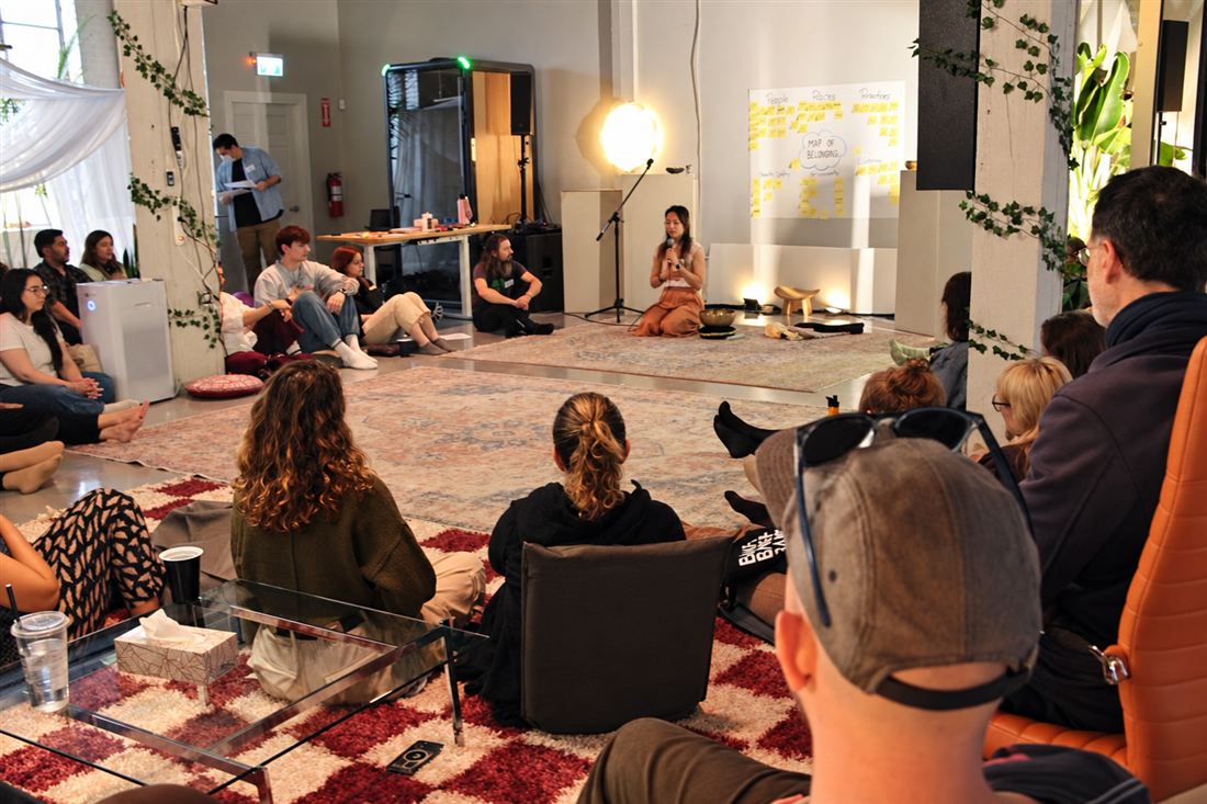 A Lighthouse gathering, with Steph Ngan speaking to a seated circle of participants